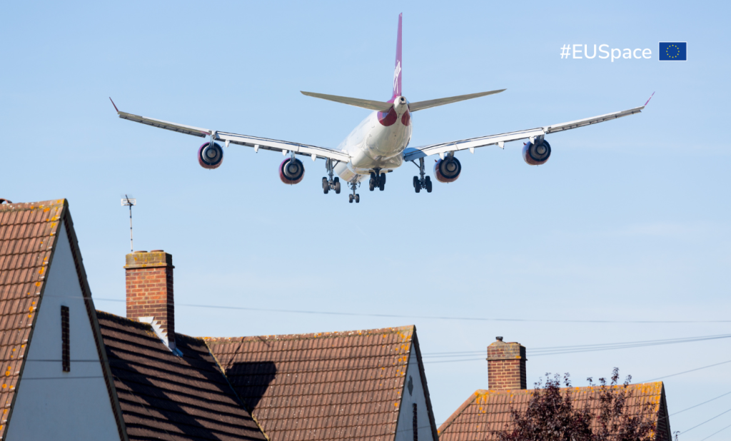 A plane flying above residential houses