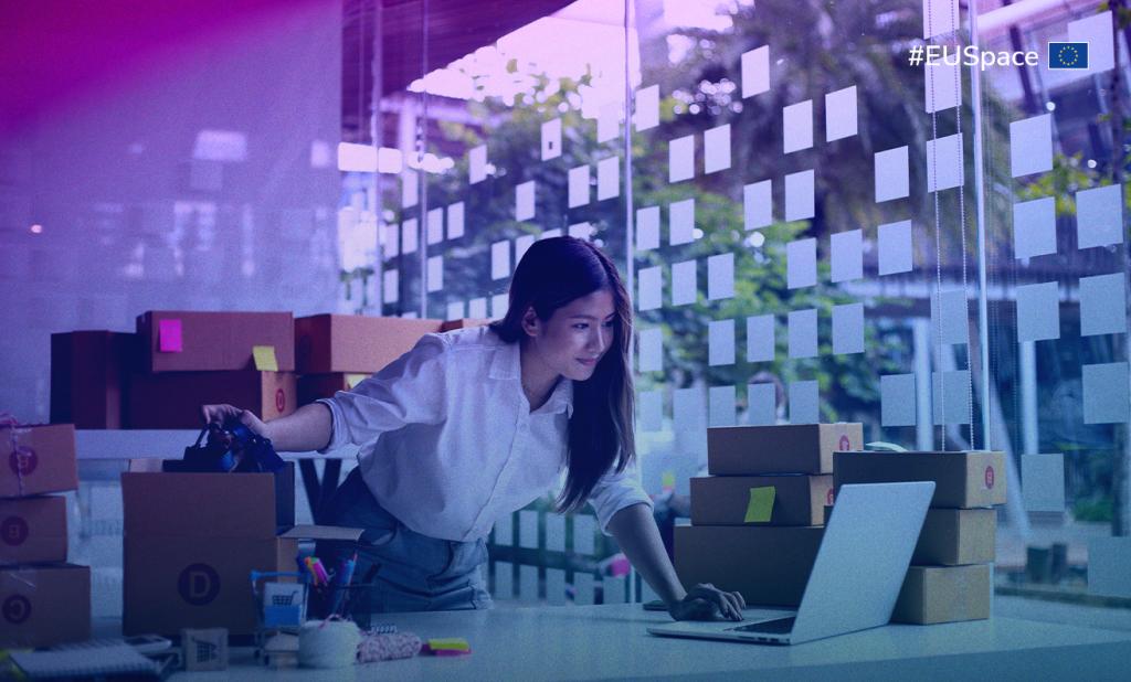 A woman typing on her laptop in a well-lit office, surrounded by office supplies and a plant. #EUSpace hashtag on the top right corner