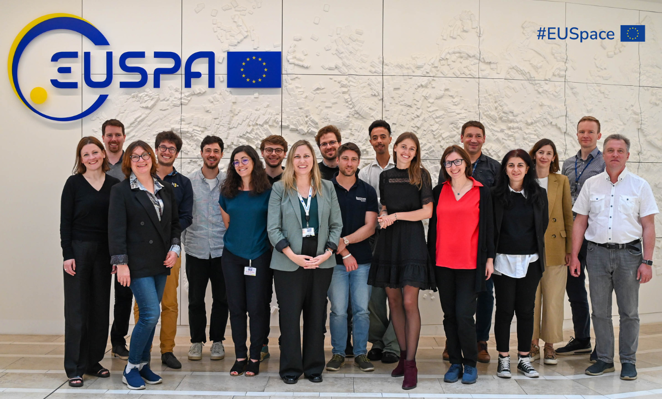 group of people in front of white wall with EUSPA logo on top left corner