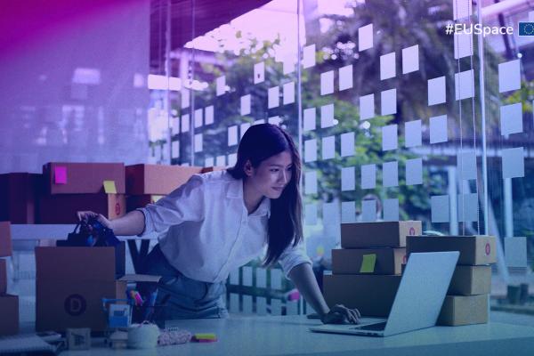 A woman typing on her laptop in a well-lit office, surrounded by office supplies and a plant. #EUSpace hashtag on the top right corner