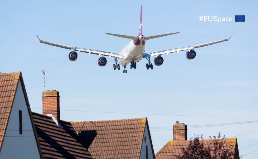 A plane flying above residential houses