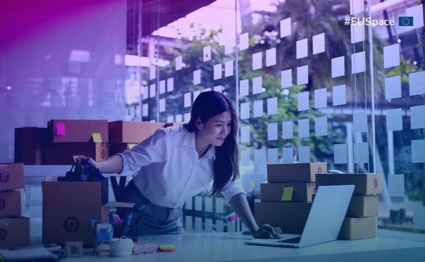 A woman typing on her laptop in a well-lit office, surrounded by office supplies and a plant. #EUSpace hashtag on the top right corner