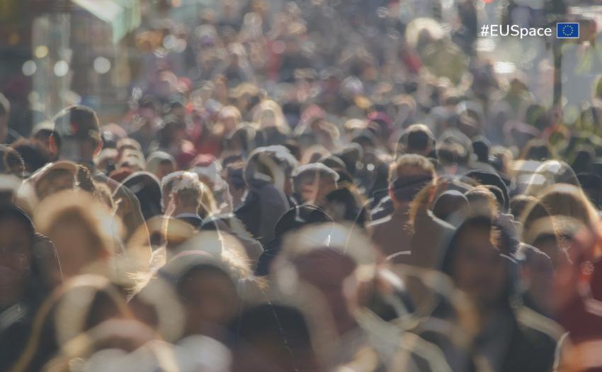 Crowd of people walking in a city